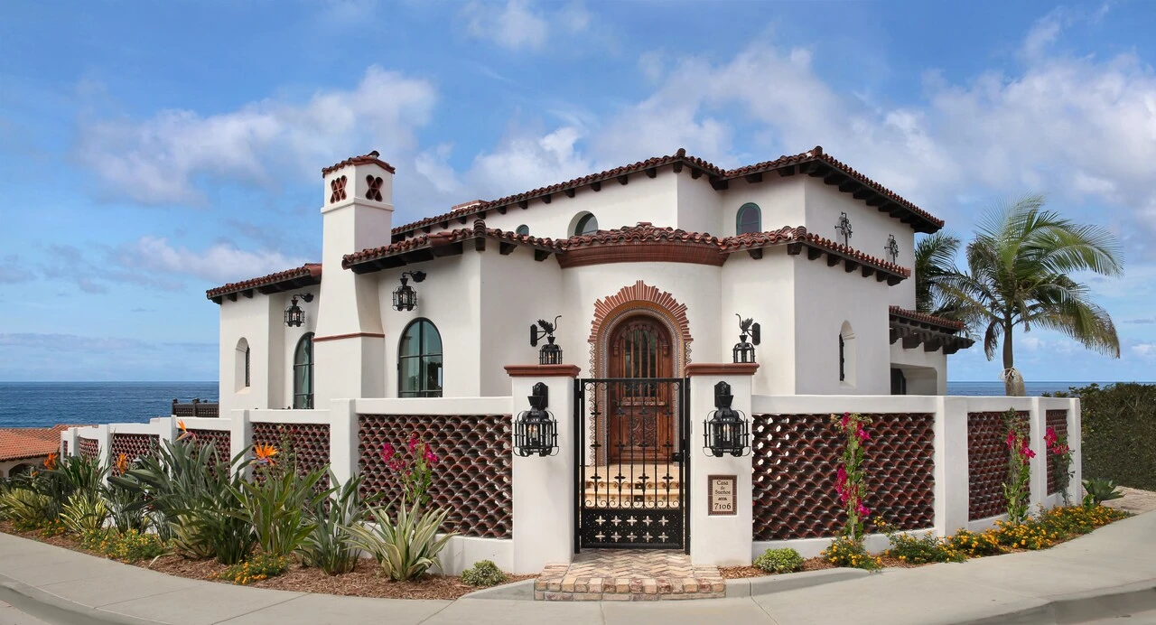 A white house with brown trim and a black door.