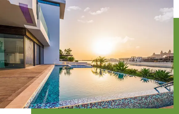 A pool with a view of the ocean and sunset.