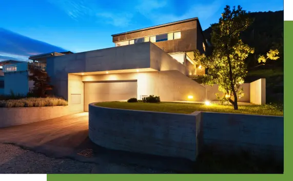 A modern house with lights on the outside of it.