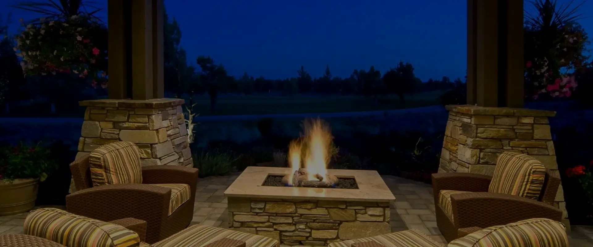 A fire pit sitting on top of a brick patio.