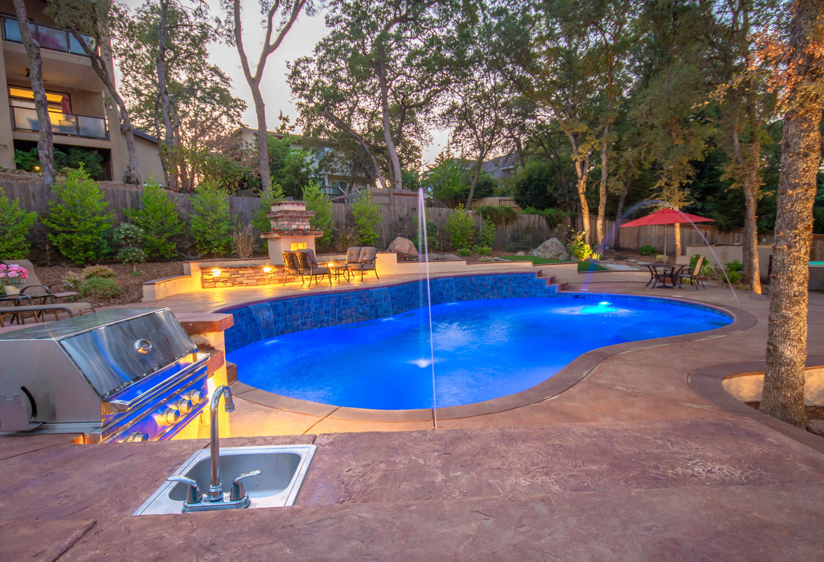 A pool with a slide and fountain in it